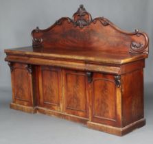 A Victorian carved mahogany sideboard with carved shaped back, the base fitted 3 drawers above