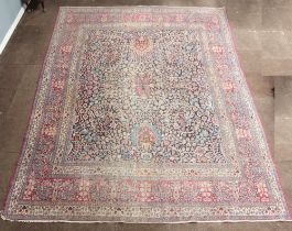 A North Persian blue and white patterned floral carpet with multi row border 384cm x 298cm In wear