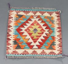 A white, green and orange ground Chobi Kilim slip rug with diamond design to the centre 50cm x 48cm