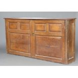 An 18th/19th Century bleached oak cabinet with shelved interior enclosed by panelled doors 101cm h x