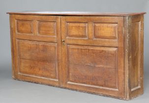 An 18th/19th Century bleached oak cabinet with shelved interior enclosed by panelled doors 101cm h x