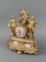 A French 19th Century timepiece with pink porcelain dial, contained in a gilt spelter case supported