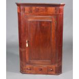 A 19th Century mahogany corner cabinet with moulded cornice fitted shelves enclosed by a panelled