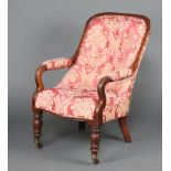 A Victorian mahogany show frame open arm chair upholstered pink floral buttoned material, raised