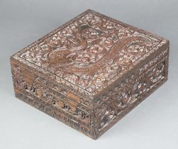 A 19th Century rectangular deeply carved camphor box with hinged lid and fall front, the interior