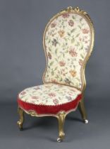 A Victorian gilt painted show frame nursing chair upholstered in tapestry material raised on