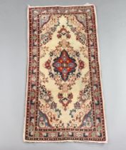 A white and floral patterned Persian rug with centre medallion 127cm x 60cm Some stains in places