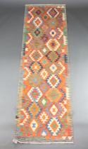 A yellow, green and brown ground Chobi Kilim runner with geometric designs 284cm x 86cm