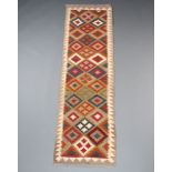 A tan, black and brown ground Maimana Kilim rug with all over geometric design 210cm x 62cm