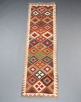 A tan, black and brown ground Maimana Kilim rug with all over geometric design 210cm x 62cm