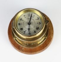 A ward room style striking wall clock with 9cm silvered dial, Arabic numerals, contained in a gilt