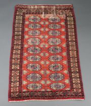 A red and brown ground Bokhara rug with 13 octagons to the centre within a multi row border 132cm