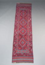 A red and blue ground Meshwani runner with 4 diamonds to the centre 248cm x 63cm