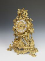 A 19th Century French 8 day striking on bell mantel clock contained in a gilt ormolu Rococo style