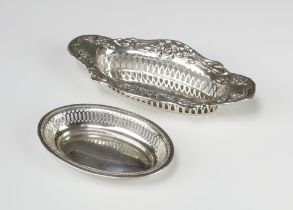 An Edwardian repousse pierced silver bon bon dish Birmingham 1910, an oval smaller ditto 800