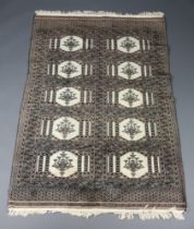 A black and white ground Bokhara rug with 10 medallions to the centre within a multi row border