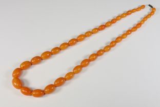 A string of graduated amber beads, 84cm