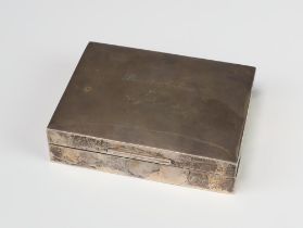 A rectangular silver cigarette box with engraved inscription Sheffield 1935