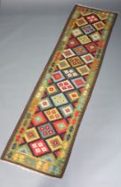 A black, green and orange ground Maimana Kilim runner with geometric design 297cm x 82cm