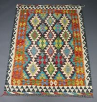 A green, black and yellow ground Chobi kilim rug with all over geometric designs 180cm x 130cm