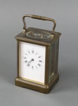 A 19th Century French 8 day carriage timepiece with 7cm enamelled dial contained in a gilt metal