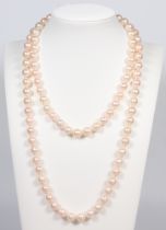 A string of cultured pearls each 7mm, with a yellow metal 750 diamond set clasp, 92cm
