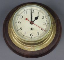 A ward room style clock, the 19cm painted dial with Arabic numerals and sweep second hand, contained