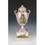 A late 19th Century Dresden 2 handled vase and later cover, raised on a square base, decorated