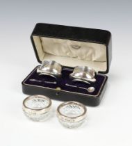 A pair of silver table salts with blue glass liners, Birmingham 1912, together with a pair of silver