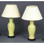 A pair of modern Chinese yellow glazed baluster table lamps on wood stands, 41cm