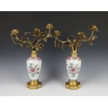 A pair of famille rose style oviform porcelain vases decorated with flowers having gilt metal