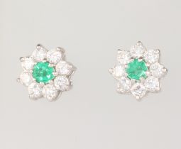 A pair of 18ct white gold emerald and diamond cluster earrings, the centre emeralds each approx. 0.