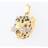 A yellow metal 750 ruby, diamond and enamelled pendant in the form of a leopards head 12.3 grams,