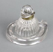 A novelty moulded glass inkwell in the form of a jockey's hat and horseshoe with white metal