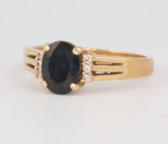 A yellow metal 750 sapphire and diamond ring, the sapphire approx. 1.25ct, size O 1/2, 4.5 grams