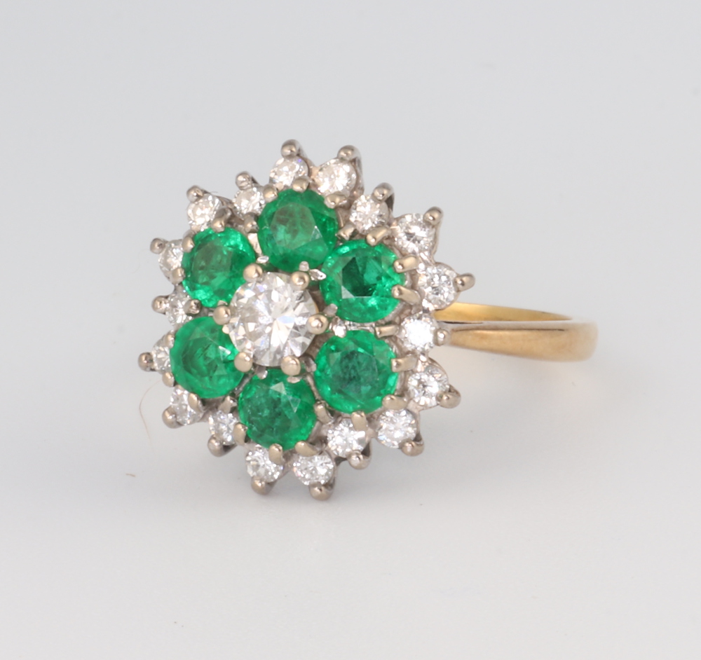 An 18ct yellow gold emerald and diamond cluster ring, the 6 brilliant cut emeralds each approx. 0.