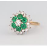 An 18ct yellow gold emerald and diamond cluster ring, the 6 brilliant cut emeralds each approx. 0.