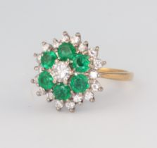 An 18ct yellow gold emerald and diamond cluster ring, the 6 brilliant cut emeralds each approx. 0.