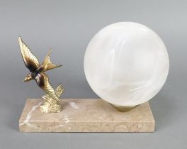 An Art Deco gilt spelter and grey marble table lamp in the form of a diving bird with opaque glass