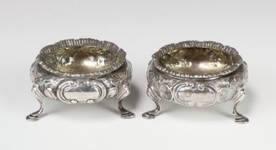 A pair of Victorian repousse silver salts with pad feet London 1862 and 1863, 123 grams