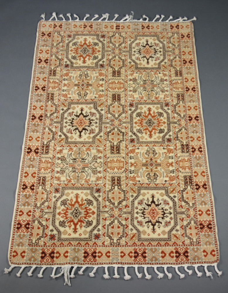 A cream and brown ground Moroccan rug having 10 rectangular panels to the centre 181cm x 119cm
