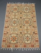 A cream and brown ground Moroccan rug having 10 rectangular panels to the centre 181cm x 119cm