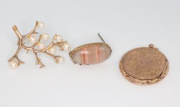 A 9ct yellow gold engraved locket, a hardstone brooch and a pearl set brooch, gross weight 12.9