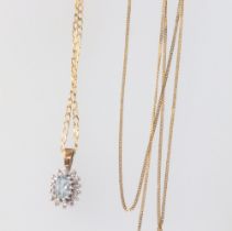 A yellow metal topaz and diamond pendant on a ditto necklace, 42cm, a ditto necklace 43cm, gross