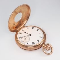 A 9ct yellow gold mechanical half hunter pocket watch with enamelled numerals and seconds at 6 o'
