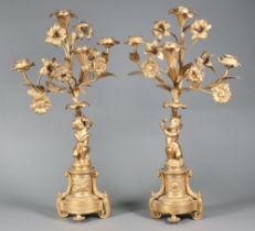 A pair of 19th/20th Century gilt metal 4 light candelabrum supported by cherubs 46cm x 27cm