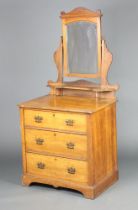 An Edwardian satinwood dressing chest with arched bevelled plate mirror above shelf, the base with 3