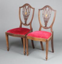 A pair of Edwardian inlaid mahogany Hepplewhite style shield back dining chairs, seats of serpentine