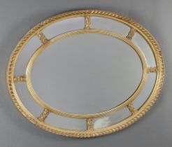 A Georgian style oval plate mirror contained a decorative gilt frame 60cm h x 77cm w Silvering to