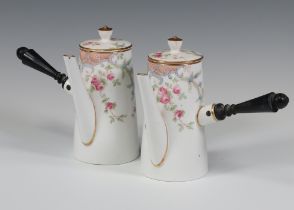 A pair of Copeland china coffee pots and lids decorated with flowers, having turned wood handles